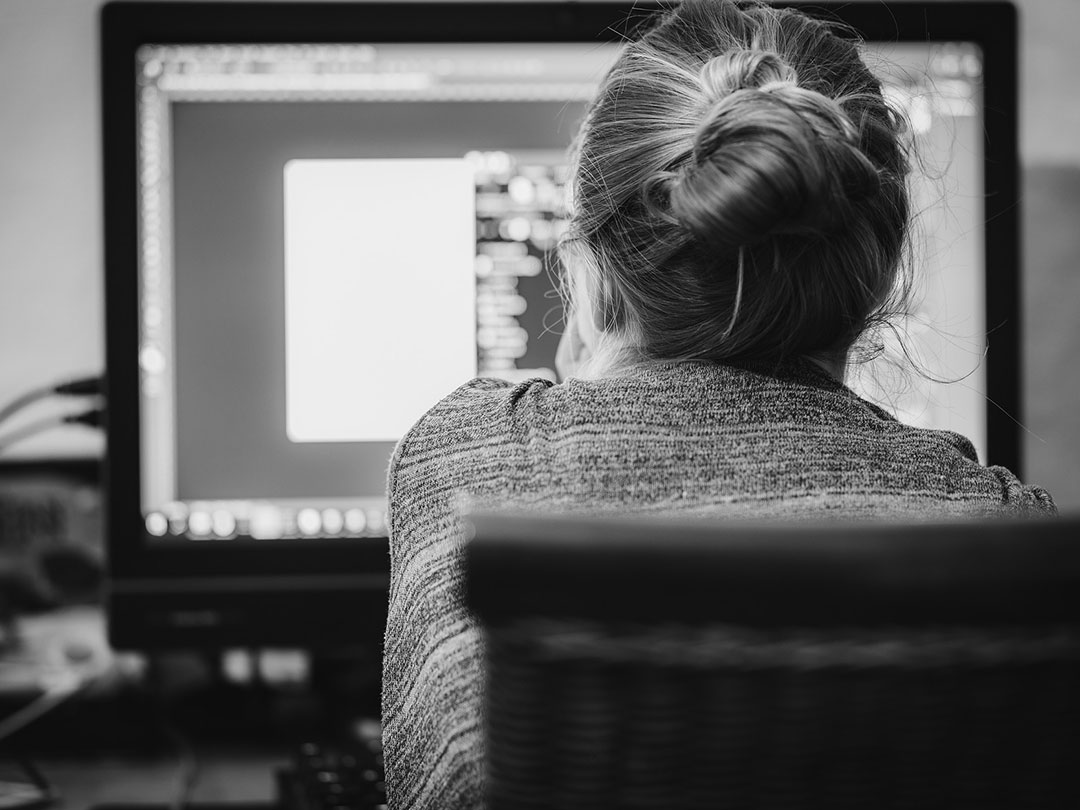 benefits-of-hiring-a-web-designer female web designer facing computer designing websites