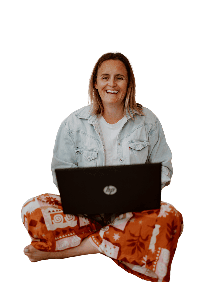 Greer from zel designs sitting working on a laptop looking casual