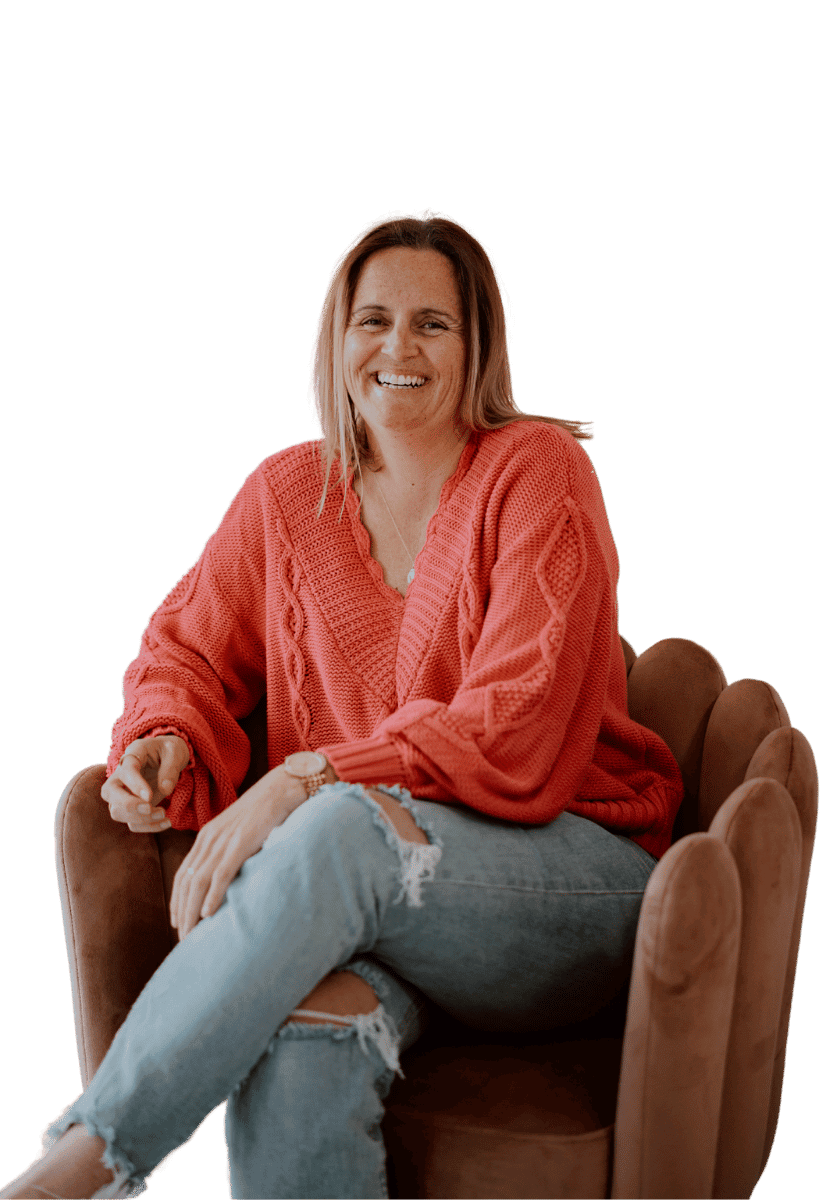 Greer from zel designs sitting in a chair smiling