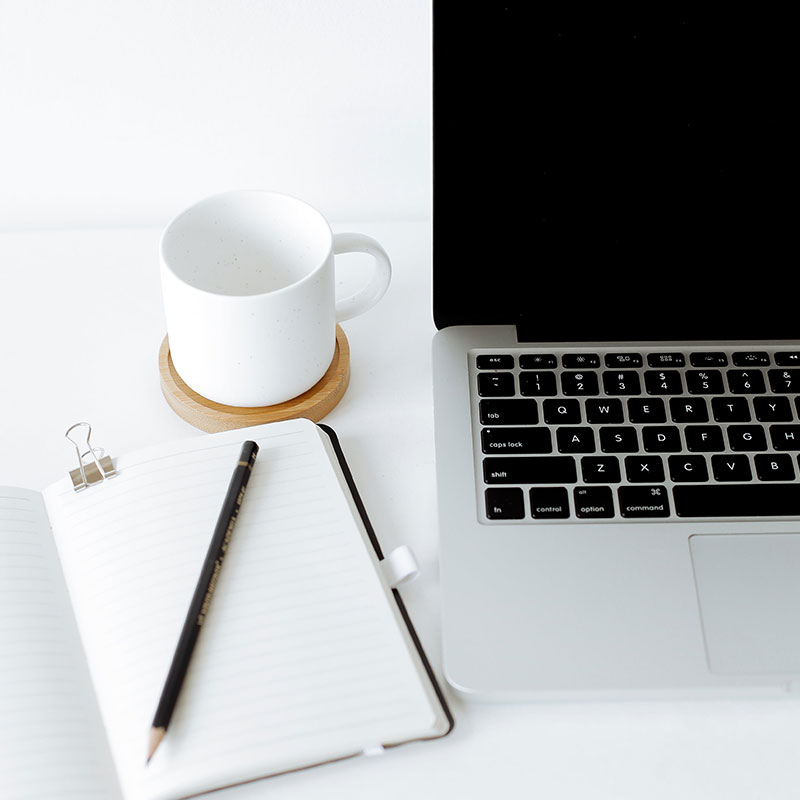 How we do SEO copywriting - blank page with laptop ready and coffee handy